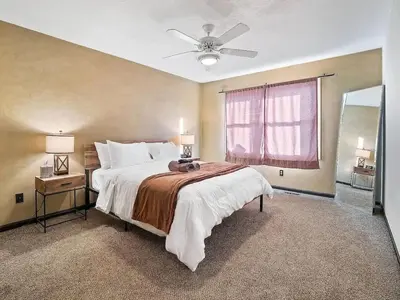 a bedroom with a large bed and a window at Fun 3 BR Home in Ohio City Game Room Sleeps 11 in Cleveland
