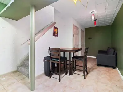 a dining room with a table and chairs at Fun 3 BR Home in Ohio City Game Room Sleeps 11 in Cleveland