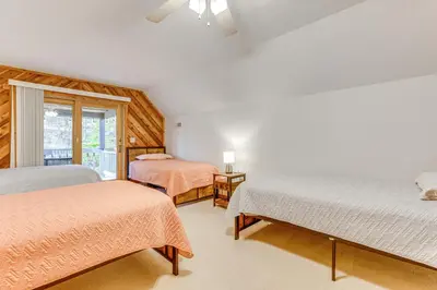 a bedroom with two beds and a window at Shady Point Retreat with Hot Tub and Pickleball! in Killbuck