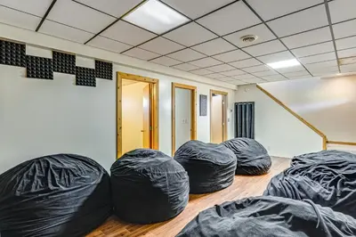 a room with four black bean bags on the floor at Shady Point Retreat with Hot Tub and Pickleball! in Killbuck