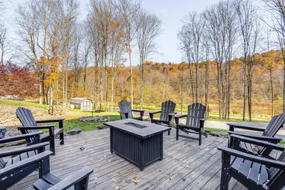 a group of chairs and a table on a wooden deck at Shady Point Retreat with Hot Tub and Pickleball! in Killbuck
