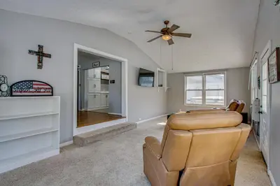 a living room with a couch and a ceiling fan at Peaceful Retreat with Private Hot Tub in New Albany in New Albany