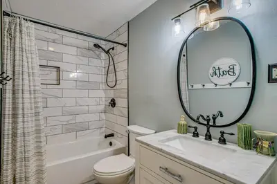 a bathroom with a sink and a toilet and a mirror at Peaceful Retreat with Private Hot Tub in New Albany in New Albany