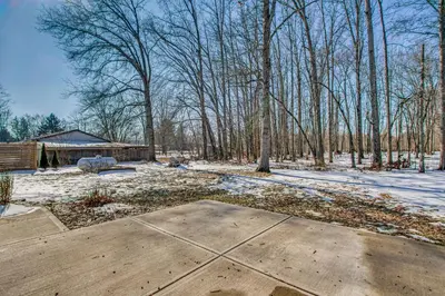 a yard with snow on the ground and trees at Peaceful Retreat with Private Hot Tub in New Albany in New Albany