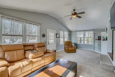 a living room with a couch and a ceiling fan at Peaceful Retreat with Private Hot Tub in New Albany in New Albany