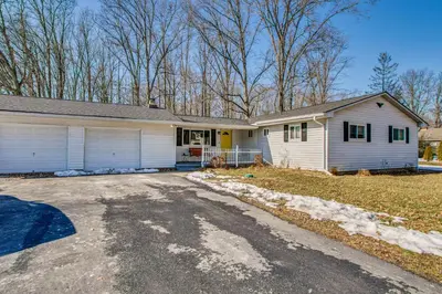 a white house with a driveway in front of it at Peaceful Retreat with Private Hot Tub in New Albany in New Albany