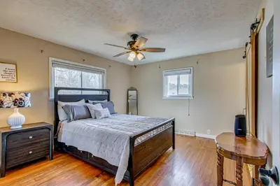 a bedroom with a bed and a ceiling fan at Peaceful Retreat with Private Hot Tub in New Albany in New Albany