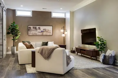 a living room with a couch and a television at Walk to OTR! Hot Tub and Movie Room at Cincy Condo in Cincinnati