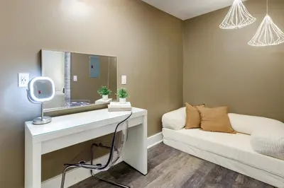 a bathroom with a white vanity and a mirror at Walk to OTR! Hot Tub and Movie Room at Cincy Condo in Cincinnati