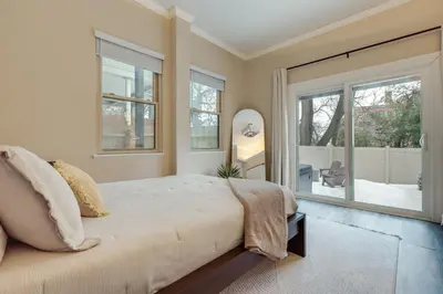 a bedroom with a large bed and a large window at Walk to OTR! Hot Tub and Movie Room at Cincy Condo in Cincinnati