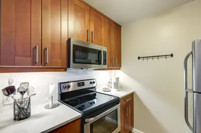 a kitchen with a stove and a microwave at Walkable Condo Near Over-the-Rhine and Hard Rock! in Cincinnati