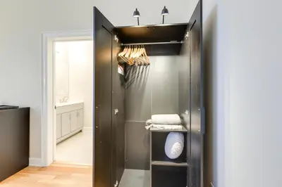 a walk in closet with a black door at Walkable Condo Near Over-the-Rhine and Hard Rock! in Cincinnati