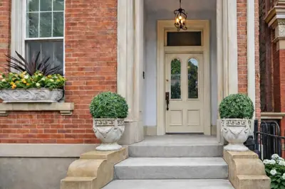 a front door of a house with two vases at Walkable Condo Near Over-the-Rhine and Hard Rock! in Cincinnati