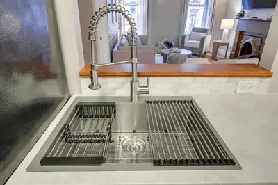 a kitchen sink with a faucet in a kitchen at Walkable Condo Near Over-the-Rhine and Hard Rock! in Cincinnati