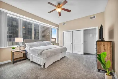 a bedroom with a bed and a ceiling fan at Downtown Flat w/ LAKE VIEW: Walk 2 Stadiums/Arenas in Cleveland