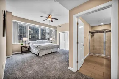 a bedroom with a bed and a ceiling fan at Downtown Flat w/ LAKE VIEW: Walk 2 Stadiums/Arenas in Cleveland