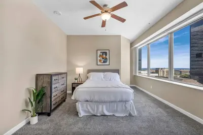 a bedroom with a bed and a ceiling fan at Downtown Flat w/ LAKE VIEW: Walk 2 Stadiums/Arenas in Cleveland