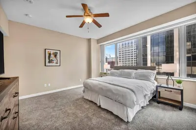 a bedroom with a large bed and a ceiling fan at Downtown Flat w/ LAKE VIEW: Walk 2 Stadiums/Arenas in Cleveland