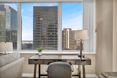an office with a desk in front of a window at LAKE VIEWS | Paid Parking | Downtown | Gym in Cleveland