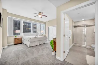 a large bedroom with a bed and a shower at LAKE VIEW Sky-Suite in the Heart of Downtown! in Cleveland