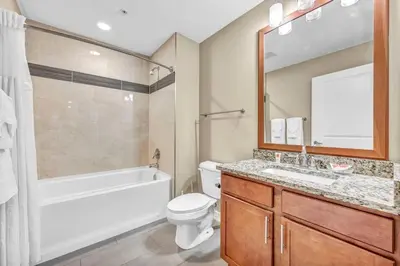 a bathroom with a tub and a toilet and a sink at LAKE VIEW Sky-Suite in the Heart of Downtown! in Cleveland
