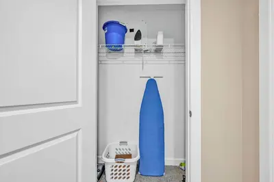 a closet with a door open with a blue surfboard at LAKE VIEW Sky-Suite in the Heart of Downtown! in Cleveland