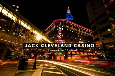 a street sign in front of a building at night at LAKE VIEW Sky-Suite in the Heart of Downtown! in Cleveland