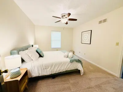 a bedroom with a bed and a ceiling fan at Premier 3BR Retreat - CVNP, Blossom & Boston Hills in Cuyahoga Falls