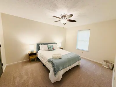 a bedroom with a bed and a ceiling fan at Premier 3BR Retreat - CVNP, Blossom & Boston Hills in Cuyahoga Falls
