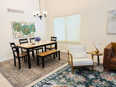 a dining room with a table and chairs at Premier 3BR Retreat - CVNP, Blossom & Boston Hills in Cuyahoga Falls