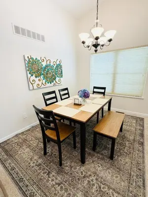 a dining room with a table and chairs at Premier 3BR Retreat - CVNP, Blossom & Boston Hills in Cuyahoga Falls