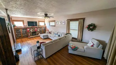 a living room with two couches and a tv at 4BR- Downtown Christmas Home in Millersburg