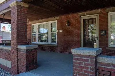 a brick house with a porch and a door at 4BR- Downtown Christmas Home in Millersburg