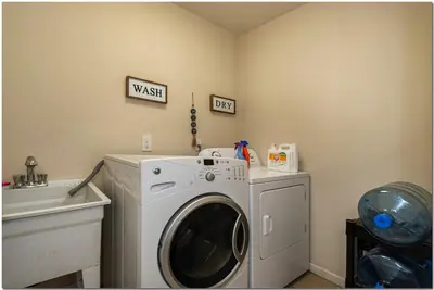 a laundry room with a washing machine and a sink at Modern home near Cleveland in Seven Hills