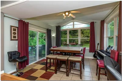a dining room with a table and chairs at Modern home near Cleveland in Seven Hills