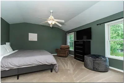 a bedroom with a bed and a ceiling fan at Modern home near Cleveland in Seven Hills