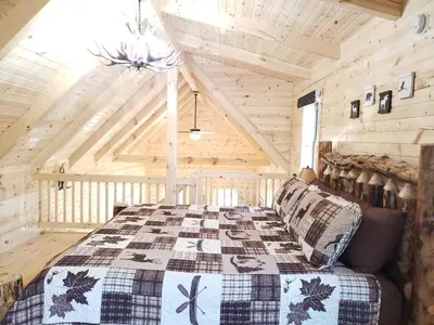 a bedroom with a bed in a wooden cabin at King of Hearts in Rockbridge
