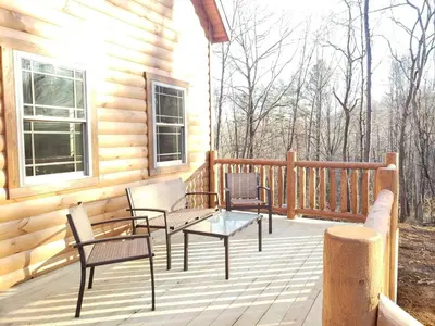 a porch with chairs and a table on a cabin at King of Hearts in Rockbridge