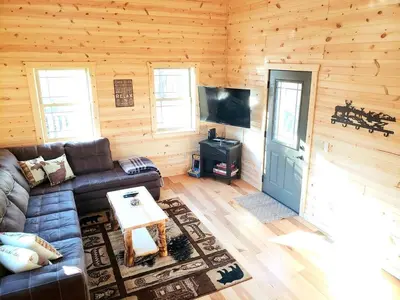 a living room with a couch and a flat screen tv at King of Hearts in Rockbridge