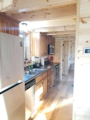 a kitchen with wooden cabinets and a refrigerator at King of Hearts in Rockbridge
