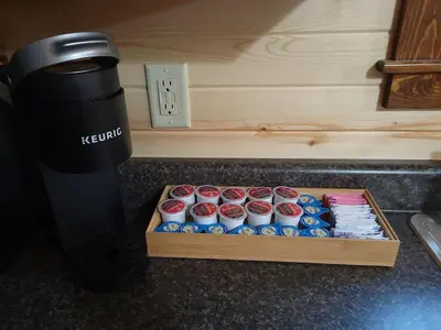 a box of cupcakes sitting on a counter next to a coffee maker at Queen of Hearts in Rockbridge