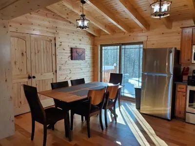 a dining room with a table and a refrigerator at Ace of Hearts in Rockbridge