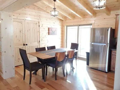 a dining room with a table and a refrigerator at Ace of Hearts in Rockbridge