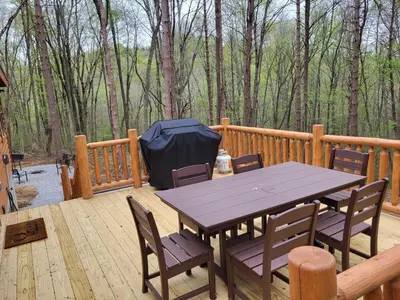 a wooden deck with a picnic table and chairs at Jack of Hearts in Rockbridge