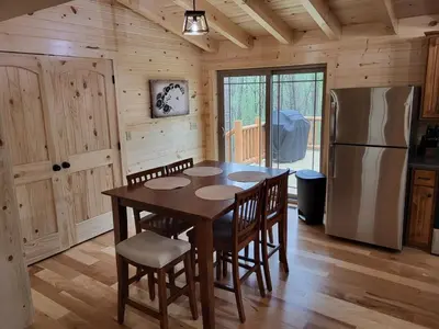a wooden kitchen with a table and a refrigerator at Jack of Hearts in Rockbridge