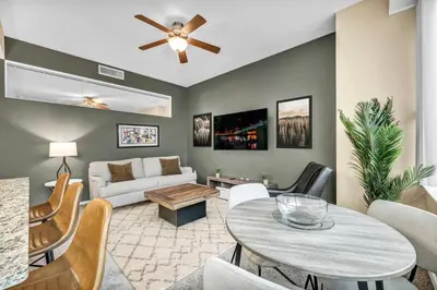 a living room with a couch and a table at Downtown Suite w/ Amazing Views in Cleveland