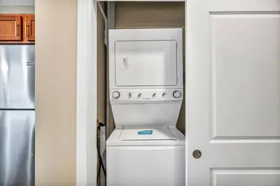 a white washer and dryer in a small kitchen at Downtown Suite w/ Amazing Views in Cleveland