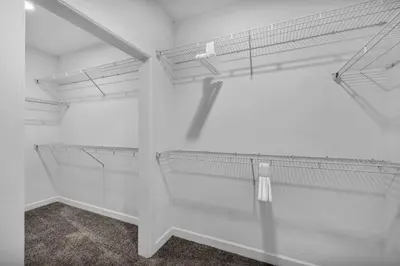 a walk in closet with white walls and white shelves at Downtown Suite w/ Amazing Views in Cleveland