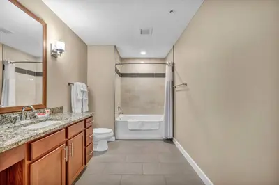 a bathroom with a shower and a toilet and a sink at Downtown Suite w/ Amazing Views in Cleveland