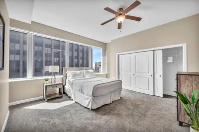 a bedroom with a bed and a ceiling fan at 21st Floor Penthouse | Amazing Views of Downtown! in Cleveland